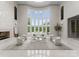 Bright living room featuring a fireplace, floor-to-ceiling windows, and luxurious white furniture on top of marble floors at 2926 Crane Rd, Waxhaw, NC 28173