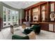 Sophisticated office featuring wood trim, glass shelving, and a large window offering a bright workspace for enhanced productivity at 2926 Crane Rd, Waxhaw, NC 28173