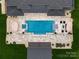 Aerial view of a home's backyard featuring a pool, patio, and beautiful landscaping at 3020 Brooks Mill Ln, Wingate, NC 28174
