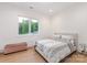 Comfortable bedroom with a large window offering natural light and a cozy bench at 3020 Brooks Mill Ln, Wingate, NC 28174