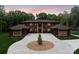 Stunning exterior elevation showcasing a large home with a circular driveway and lush landscaping at 3020 Brooks Mill Ln, Wingate, NC 28174