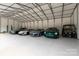 The interior of a large garage with many cars parked inside at 3020 Brooks Mill Ln, Wingate, NC 28174