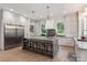 Well-appointed kitchen with a center island, custom cabinetry, and professional-grade appliances at 3020 Brooks Mill Ln, Wingate, NC 28174