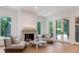 Bright living room with fireplace, marble table, and access to the outdoors through glass doors at 3020 Brooks Mill Ln, Wingate, NC 28174