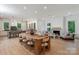 Spacious open-concept living area featuring a fireplace, modern kitchen, and wooden dining table at 3020 Brooks Mill Ln, Wingate, NC 28174