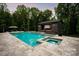 Backyard pool featuring a spa, poolside pavilion and lush landscaping at 3020 Brooks Mill Ln, Wingate, NC 28174