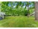 Sprawling backyard featuring lush green grass, mature trees, and a comfortable hammock for relaxation at 3400 Reid Ave, Charlotte, NC 28208