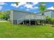 Exterior back of the home featuring a back deck with stairs and lush green grass at 3400 Reid Ave, Charlotte, NC 28208