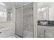 Bathroom featuring a glass bowl sink and shower with sliding doors and white marble-patterned tile at 3400 Reid Ave, Charlotte, NC 28208