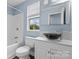 Bathroom featuring blue walls, large vanity mirror, and a black vessel sink at 3400 Reid Ave, Charlotte, NC 28208