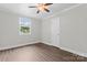 Neutral bedroom with wood-look floors, neutral paint, and natural light at 3400 Reid Ave, Charlotte, NC 28208