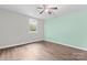 Bedroom featuring a window with view of landscaping and wood-look flooring at 3400 Reid Ave, Charlotte, NC 28208