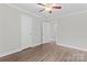 Bright bedroom featuring a ceiling fan, neutral walls, and wood-look flooring at 3400 Reid Ave, Charlotte, NC 28208