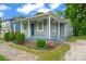 Charming home with a welcoming front porch, complemented by colorful landscaping and a stone walkway at 3400 Reid Ave, Charlotte, NC 28208
