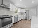 Modern kitchen featuring stainless steel appliances, subway tile backsplash, and wood-look flooring at 3400 Reid Ave, Charlotte, NC 28208