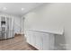 Kitchen area with a stainless steel refrigerator, countertop and white cabinets at 3400 Reid Ave, Charlotte, NC 28208