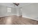 Bright living room with wood-look floors, neutral paint, a ceiling fan and natural light at 3400 Reid Ave, Charlotte, NC 28208