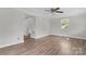 Bright living room with wood-look floors, neutral paint, and a ceiling fan at 3400 Reid Ave, Charlotte, NC 28208