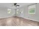 Bright living room with wood-look floors, neutral paint, with front door entrance and natural light at 3400 Reid Ave, Charlotte, NC 28208