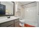 Bathroom features a tub-shower, modern sink, cabinets, and wood look flooring at 3912 Grace Ct, Indian Trail, NC 28079