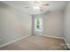 Simple bedroom with neutral carpet, white window trim, and ceiling fan at 3912 Grace Ct, Indian Trail, NC 28079