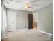 Bedroom featuring neutral walls, carpet, ceiling fan, and double closet at 3912 Grace Ct, Indian Trail, NC 28079