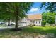 Beautifully landscaped home with mature trees, lush green lawn, and attached garage at 3912 Grace Ct, Indian Trail, NC 28079