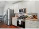 Well-appointed kitchen features stainless steel appliances and white cabinetry at 3912 Grace Ct, Indian Trail, NC 28079