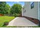 The backyard patio space features a large tree and manicured lawn at 3912 Grace Ct, Indian Trail, NC 28079