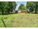 Spacious backyard with lush lawn and mature trees providing ample shade and privacy at 4250 N Center St, Hickory, NC 28601