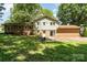 View of the home's backyard featuring a mix of brick and siding, accessible from a patio at 4250 N Center St, Hickory, NC 28601