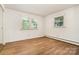 Empty bedroom with hardwood floors and two windows providing ample natural light at 4250 N Center St, Hickory, NC 28601