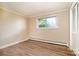This bedroom features wood floors, neutral walls and a window overlooking trees outside at 4250 N Center St, Hickory, NC 28601