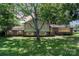 Charming two-story home with brick accents, surrounded by mature trees and a lush lawn at 4250 N Center St, Hickory, NC 28601