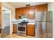 Kitchen features stainless steel appliances, wood cabinets and an adjacent dining area at 4250 N Center St, Hickory, NC 28601