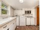 Well-lit laundry area featuring washer, dryer, sink, and storage options at 4250 N Center St, Hickory, NC 28601