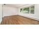 This living room features wood floors, white walls and a large picture window with blinds at 4250 N Center St, Hickory, NC 28601