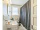 Traditional bathroom with pedestal sink, black and white tile flooring, and shower/tub combo at 432 4Th Street Sw Pl, Hickory, NC 28602