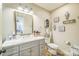 Bright bathroom featuring a vanity with marble countertop, framed mirror, and toilet at 432 4Th Street Sw Pl, Hickory, NC 28602