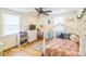 Bright bedroom featuring a whimsical canopy bed, hardwood floors, and a ceiling fan at 432 4Th Street Sw Pl, Hickory, NC 28602