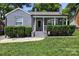 Charming brick home featuring a cozy front porch with well-manicured landscaping and inviting curb appeal at 432 4Th Street Sw Pl, Hickory, NC 28602