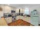 Well-appointed kitchen with stainless steel appliances, dark countertops, and vintage-style refrigerator at 432 4Th Street Sw Pl, Hickory, NC 28602
