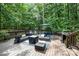 Spacious wooden deck with outdoor seating, grill, and beautiful green trees surrounding the area at 4716 Heatherton Pl, Charlotte, NC 28270