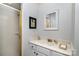Bathroom featuring vanity with solid surface counters and a step-in shower at 4716 Heatherton Pl, Charlotte, NC 28270