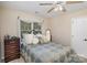 Bedroom with a ceiling fan, window, and neutral walls at 4716 Heatherton Pl, Charlotte, NC 28270