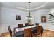 Formal dining room with hardwood floors, elegant crown molding, and a modern chandelier at 4716 Heatherton Pl, Charlotte, NC 28270