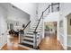 Bright two-story foyer with hardwood floors, staircase with black and white railing, and open sightlines at 4716 Heatherton Pl, Charlotte, NC 28270