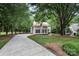 Charming home with mature landscaping and a long driveway leading to the house at 4716 Heatherton Pl, Charlotte, NC 28270