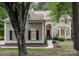 Inviting home exterior with a red front door, arched transom window, and well-manicured landscaping at 4716 Heatherton Pl, Charlotte, NC 28270