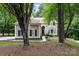 Inviting front exterior with a well-maintained lawn, walkway, and mature trees at 4716 Heatherton Pl, Charlotte, NC 28270